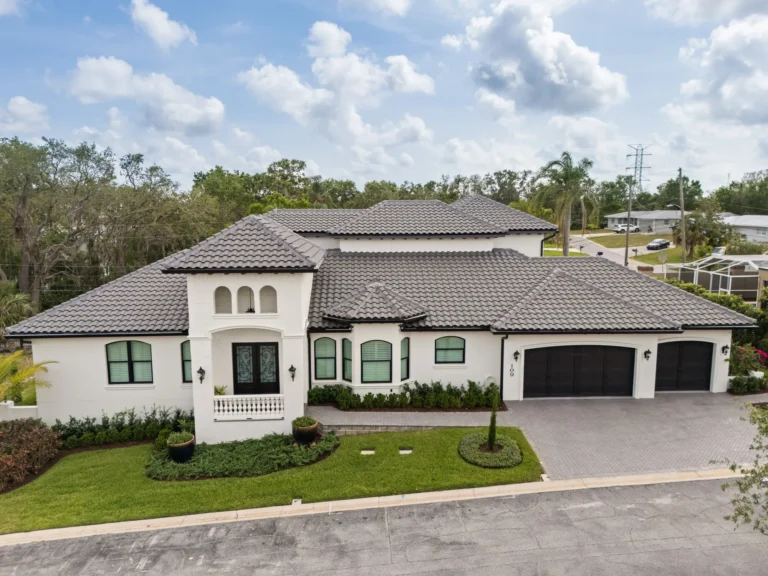 Mediterranean-style custom home built by Halo Industrial with tile roof and three-car garage