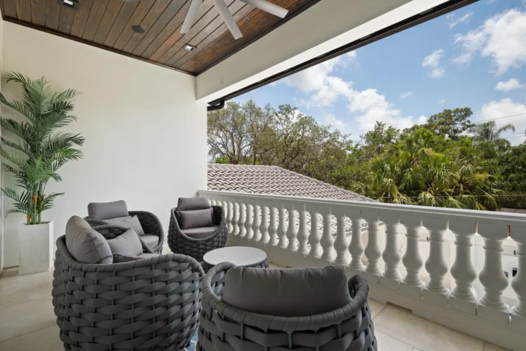 Covered outdoor patio with balustrade railing and lounge seating built by Halo Industrial