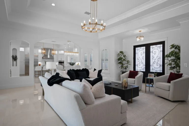 Open living and dining space with marble flooring and chandelier in a Halo Industrial build